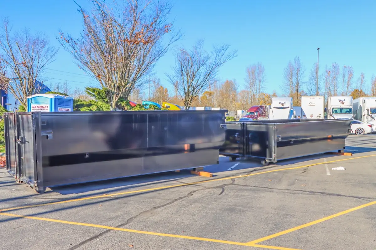Professional dumpster rental service with roll-off container on residential driveway in Gardendale